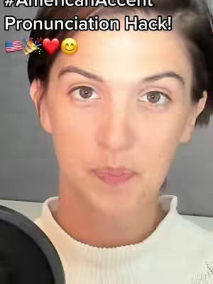 A close-up shot of a woman's from the chest up with the face as the prominent element. The lighting is natural, and the background is slightly blurred. The video title has the text overlay in the image. There are a few emojis and flags. She is wearing a white top. The background is dark.