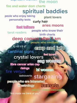 A selfie-style shot featuring a person, with a collection of word tags overlaid on the image, presented in a cloud-like arrangement. The person's face is partially visible, with a hand in the foreground, and text elements of various colors and sizes are scattered around, creating a visually dense composition.