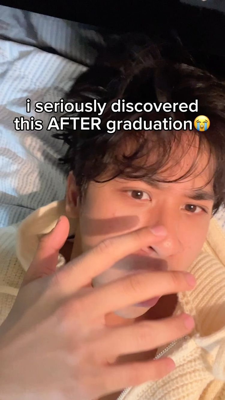 A close-up shot of a young man's face, angled upwards. He's on a bed, looking directly at the camera with a slightly surprised expression. Text overlayed on the image states, 'i seriously discovered this AFTER graduation'.