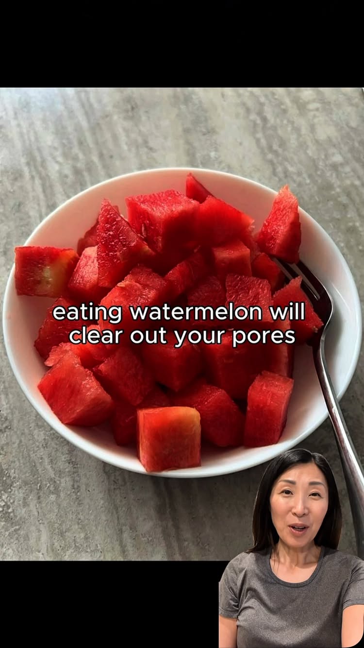 The image features a white bowl filled with diced watermelon. The watermelon is a vibrant red, and the pieces are arranged in a seemingly random manner. A silver fork lies next to the bowl. Below, a woman is featured in the bottom panel of the cover image looking and smiling at the viewers.
