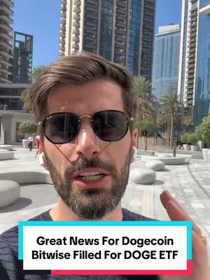 A man with sunglasses stands outdoors, partially in the frame. The background includes high-rise buildings and a clear sky, suggesting an urban setting. A text overlay states, 'Great News For Dogecoin Bitwise Filled For DOGE ETF.'
