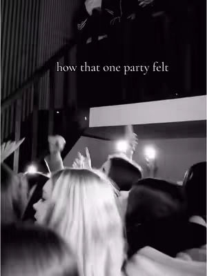 A black and white photo captures a party scene with a crowd. The focus is on a woman with light-colored hair looking to the left. The background blurs into a sense of movement and is lit with some bright lights. The text overlay reads, 'how that one party felt.'