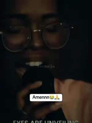 A close-up shot focuses on the face of a person wearing glasses in a dark setting. The main character is partially visible.