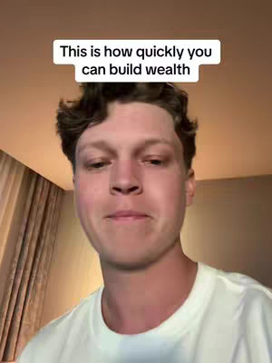 A man with light skin and brown hair looks directly at the camera. He is wearing a white t-shirt. Above his head is a white rectangle with black text.