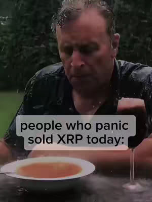 A man sits at a table outside, looking down with a sorrowful expression. In front of him is a bowl of soup and a glass of wine. Raindrops are visible, and a caption states, "people who panic sold XRP today:"