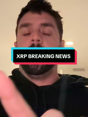 A man with dark hair and a short beard is centered in the frame, his eyes closed. Above him, a text overlay reads 'XRP BREAKING NEWS' in white text on a turquoise and red background. The overall composition is simple with a neutral background.