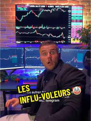 A man with surprised expression sitting in an office, with multiple computer screens displaying trading graphs in the background. A text overlay with a clown emoji is visible.