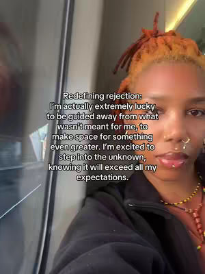 A selfie-style video cover featuring a woman with orange-tinted dreadlocks and multiple face piercings. She is looking towards the camera, and text overlays are present on the frame.
