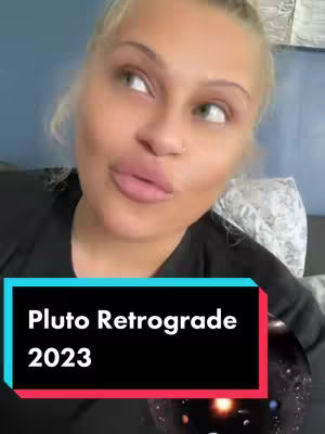 A woman with blonde hair gazes upwards thoughtfully. She has fair skin, full lips, and is wearing a black top. Overlay text in a blue and red rectangular box reads "Pluto Retrograde 2023".