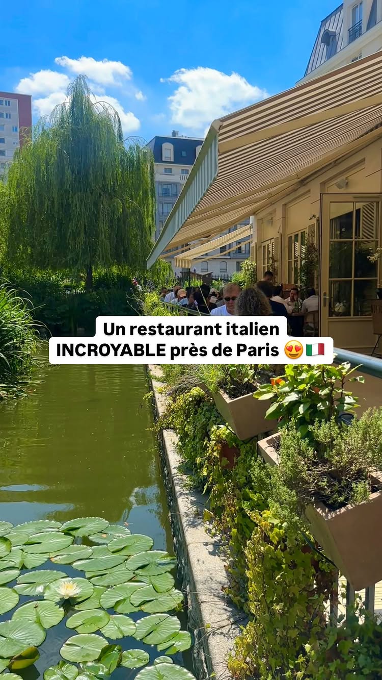 The cover image shows an Italian restaurant with a terrace next to a canal with water lilies. The facade is white with a beige awning. Text overlays the image with information about the restaurant.