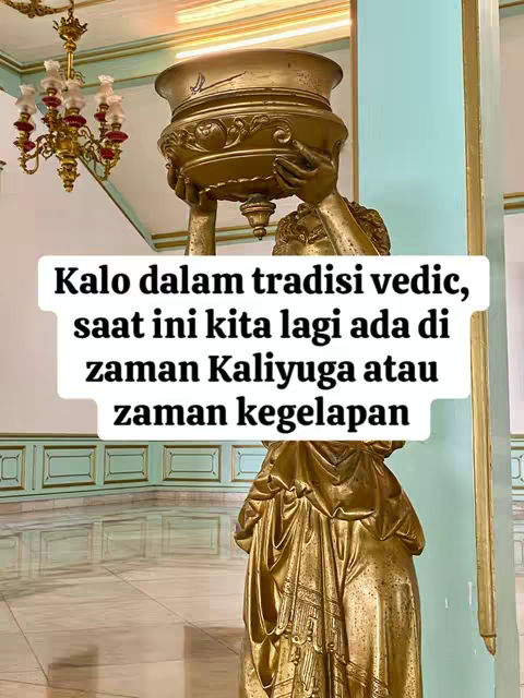 The image showcases a golden statue of a woman in a classical pose, holding a large golden bowl aloft. Overlayed on the image is white text with a black outline, and in the background, the interior of what appears to be a building with architectural features, some gold and turquoise. The lighting suggests a bright source, illuminating the statue and surrounding area.