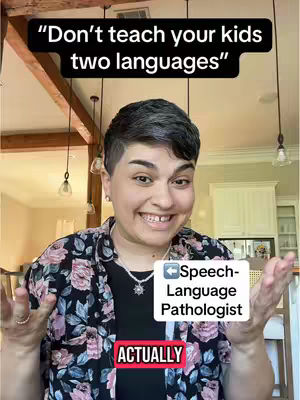 A person with short, dark hair smiles broadly at the camera, set against a homey backdrop of wooden beams and hanging lights. The person wears a floral shirt and jewelry. Overlay text in the image reads, 'Don't teach your kids two languages' and other supporting texts.