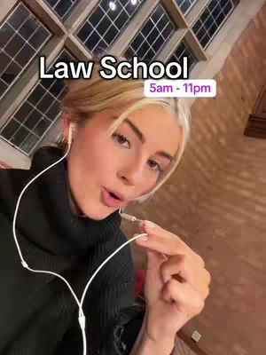 A young woman with blonde hair and fair skin is the central focus. She gazes slightly off-camera with a thoughtful expression. She wears a black turtleneck and has white earphones, holding one near her mouth. The background features a large, ornate window with a brown, textured wall. Text overlays identify the setting and key times. The image creates a sense of introspection and daily activity. The color palette is warm, with a balance of light and dark tones.