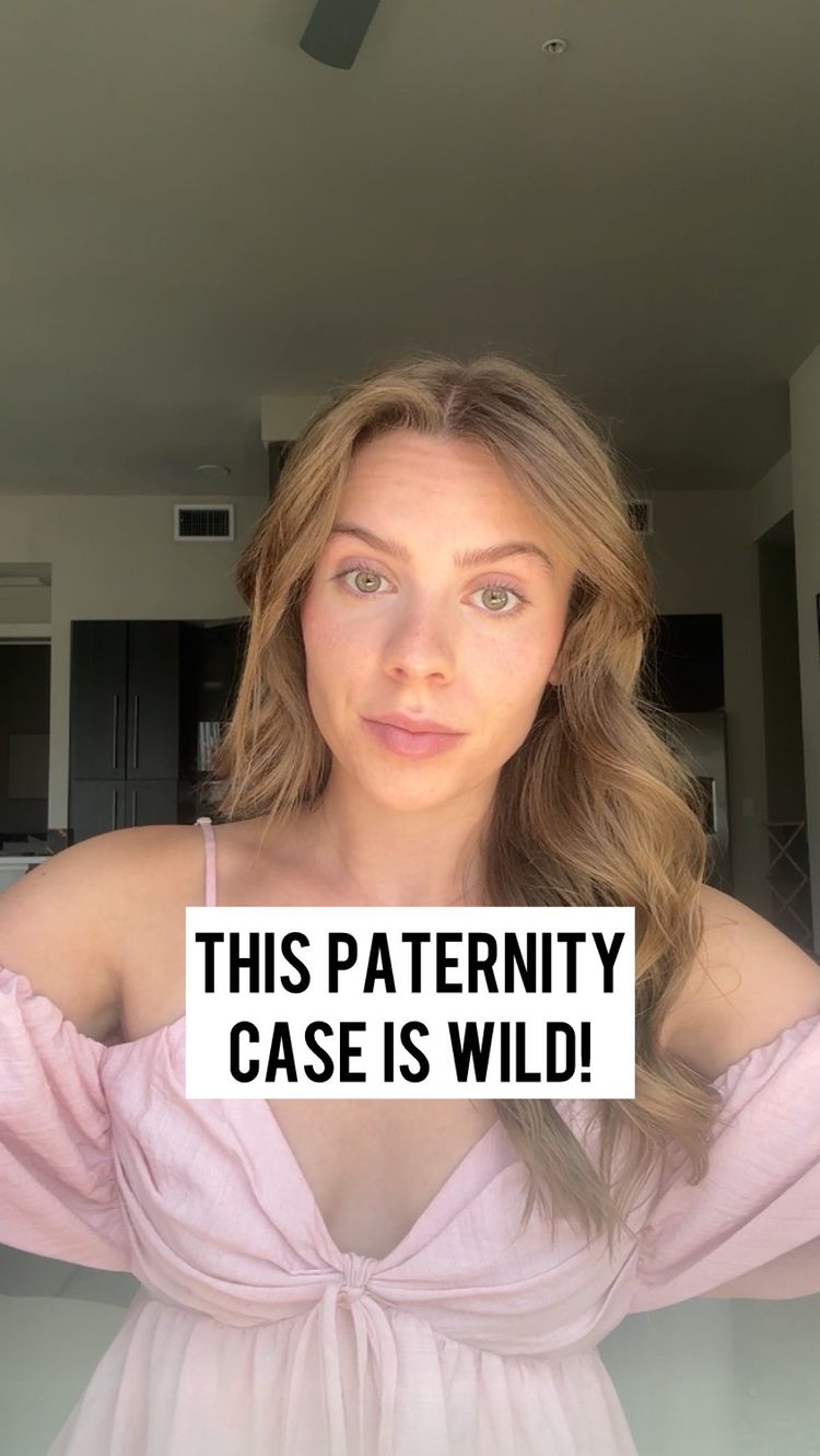 A selfie-style shot featuring a young woman with blonde hair looking directly at the camera. She is wearing a pink, off-the-shoulder top. A white rectangle with black text that says "THIS PATERNITY CASE IS WILD!" is overlaid on her.