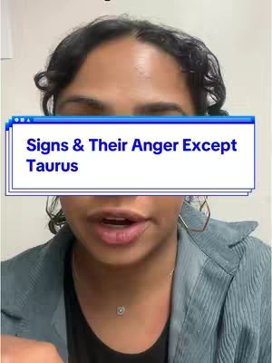 A person's face is centered in the frame, against a mostly blurred background. A rectangular text box is superimposed across the bottom half, containing text. The person has dark curly hair and is wearing a blue jacket over a black top. The background is blurred, but it appears to be an indoor setting.
