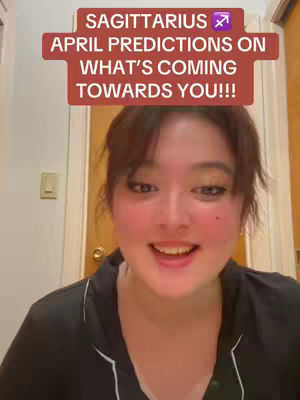 A woman with dark hair and fair skin is centered in this selfie-style shot. She smiles at the camera, with the top third of the image occupied by a reddish-brown text overlay. The background appears to be a domestic space, with a wooden door visible behind her.