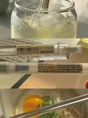 The cover image is a styled shot of a workspace or meal. The composition appears aesthetic and curated, showing elements like a glass of water with ice, writing pens, and what appears to be food, such as a fried egg. The image uses a muted and consistent color palette, providing a sense of calm and simplicity.