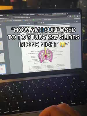 A person's hands are visible typing on a laptop keyboard below the screen. The screen displays a slide from a presentation on Gas Exchange, as well as a line of text in a text-overlay. A diagram of the respiratory system is on the slide.
