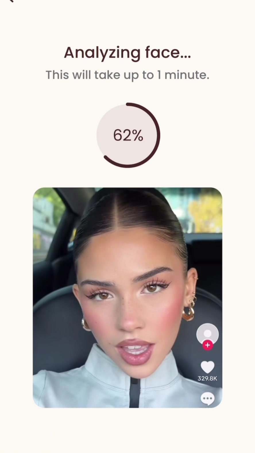 The image is a close-up selfie of a woman with a well-done makeup look. She's positioned in the car. The woman has light skin, brown eyes, and is smiling slightly. Her hair is pulled back in a neat bun. The background in part of the car.