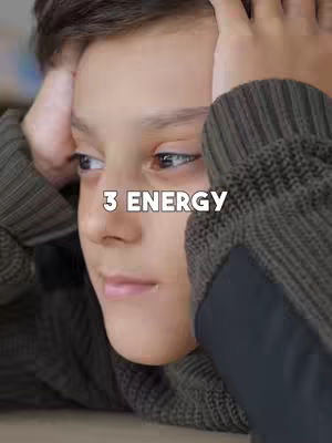 A close-up shot of a young boy with his hands on his head, looking off to the side. The image is framed to show his face and the upper part of his body, with text overlayed.