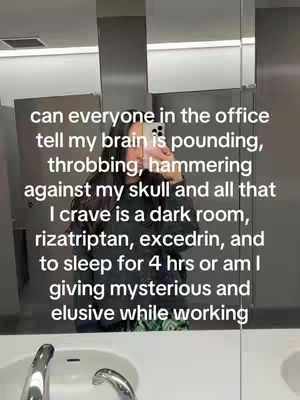 A mirror selfie in a bathroom with a woman holding a phone up to her face. She is in front of a white sink and other bathroom fixtures. Text is overlaid on the image.