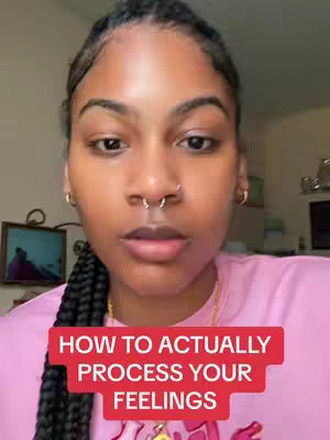 The cover image features a close-up of a woman with dark skin, framed from the chest up. She directly faces the camera, her dark hair styled in braids. She's wearing a pink shirt and her expression is serious, with a slight pursing of the lips. A text overlay in a red rectangle states, 'HOW TO ACTUALLY PROCESS YOUR FEELINGS.' The background is blurred, with hints of a room.