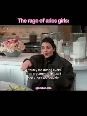 The image shows a woman in a kitchen setting, appearing surprised with a hand gesture. Overlaid text indicates a zodiac theme related to Aries signs and their emotional tendencies. The composition includes a well-lit kitchen with various elements like a countertop, kitchenware, and floral decorations.