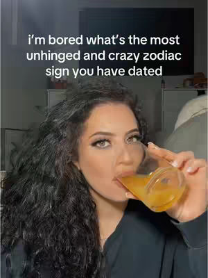 A woman with long, curly dark hair is drinking from a glass, with text overlayed on the top. The background is softly blurred and appears to be an interior.
