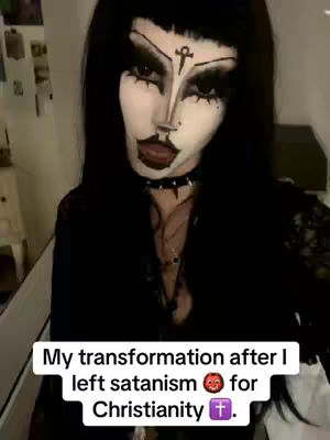 A close-up of a person with dramatic black and white makeup. The person has long black hair, a stark white face, dark eye makeup, and a black lip. Text at the bottom reads, "My transformation after I left satanism for Christianity." The overall effect is striking and contrasting.