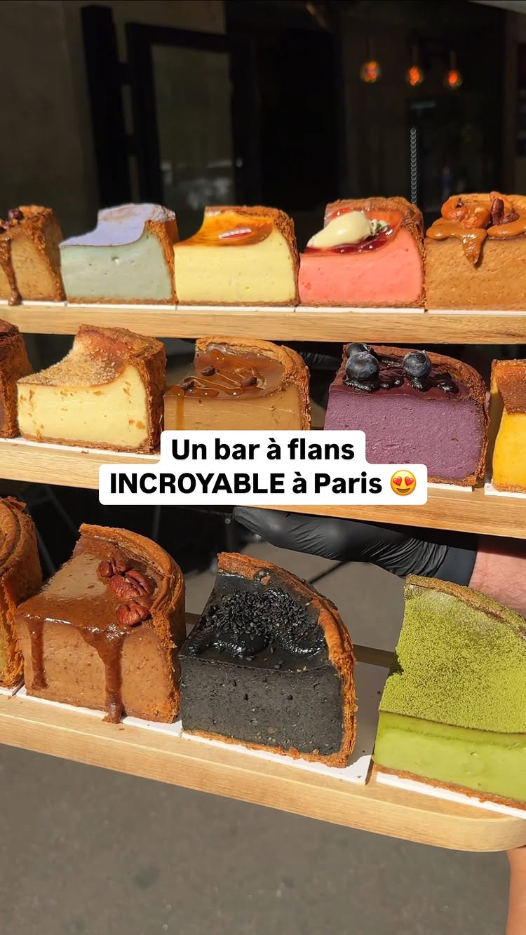 The cover image displays a variety of colorful flan slices arranged on a wooden shelf. The flans are topped with various ingredients and have different colors, indicating flavors such as vanilla, pistachio, chocolate, and others. The composition is well-lit, highlighting the desserts and creating an appealing visual.