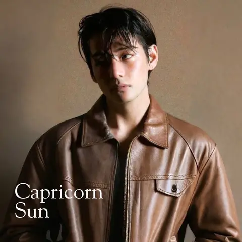 The cover image features a person with dark hair and a brown leather jacket against a brown background. The image is well-lit, with some lighting on the face and hair. The text overlay reads 'Capricorn Sun' in a clean, straightforward font at the bottom.