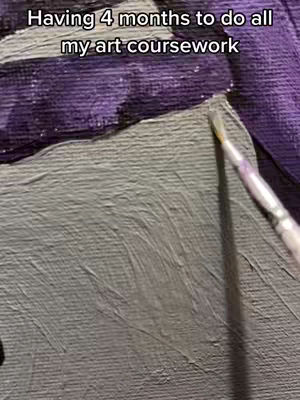 The image shows a close-up of a canvas being painted, with a paintbrush in view applying paint. The canvas shows both an area of gray and a purple area, as well as some brush strokes. The upper left portion shows the text, "Having 4 months to do all my art coursework."