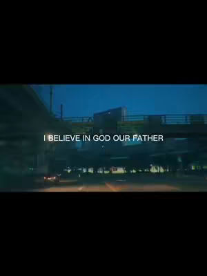 The cover image features a low-angle shot of a road and bridge at dusk or night. In the background, there's what appears to be a city skyline with various lights. Text overlaid on the image reads: "I BELIEVE IN GOD OUR FATHER."