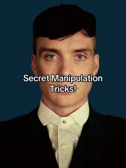 A mid-shot of a man in a suit against a dark blue background. The man is fair-skinned, with short, dark hair. He looks toward the camera with a serious expression. Overlayed at the front is white text.