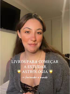 A selfie-style video cover image featuring a young woman with long, brown hair. She's wearing a gray sweater over a black and lace top. Text overlays in the lower center and bottom, with the background consisting of a home setting.