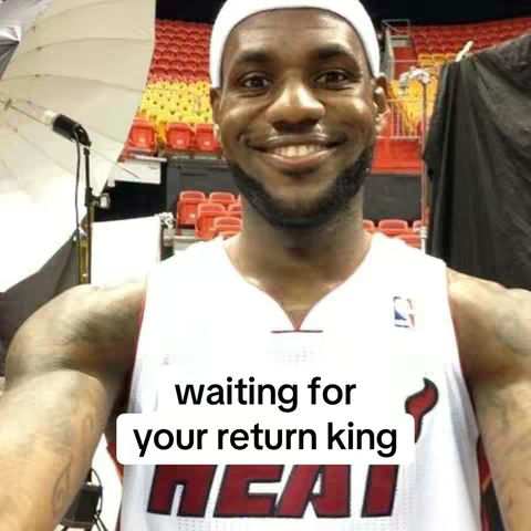 A selfie of LeBron James, smiling, wearing a white headband and a Miami Heat jersey. Text overlay says \"waiting for your return king\". The background is a basketball arena.