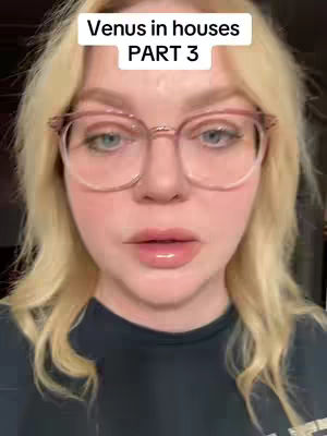 A close-up shot of a woman with blonde hair, wearing glasses, and looking directly at the camera. The background is out of focus but appears to be indoors. The woman has fair skin, and her lips are glossy. Text at the top reads "Venus in houses PART 3".