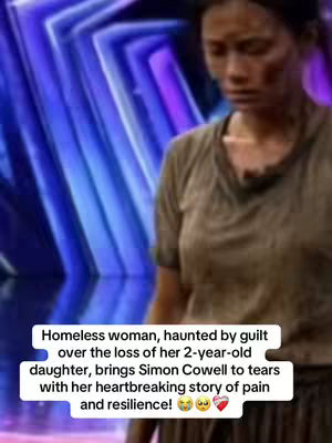The cover image features a woman captured from the waist up, set against a blurry, colorful background with blue and purple hues. The woman is the focal point, dressed in a brown t-shirt and appears to look downcast, which may suggest an emotional tone. In the bottom part of the image, a white rectangular box contains the text "Homeless woman, haunted by guilt over the loss of her 2-year-old daughter, brings Simon Cowell to tears with her heartbreaking story of pain and resilience!" The text is set in a white font which creates the contrast from the background.