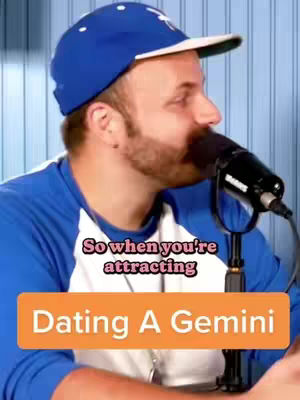 A man wearing a blue baseball cap and a blue and white shirt sits in front of a microphone. Text overlayed on the image reads, "So when you're attracting Dating A Gemini." The background appears to be a light blue, vertical-striped pattern.