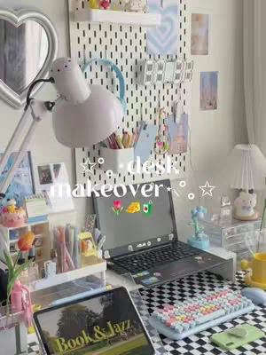 A well-organized desk with a heart-shaped mirror, a white lamp, and a computer is set up and ready for studying. A pegboard with various items like pens and small decor adds to the space's appeal.