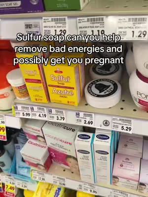 The image shows a close-up of a store shelf filled with various products. Boxes of sulfur soap are prominently displayed. Text overlays appear at the top, and the image is well-lit, focusing on product arrangement and price tags.