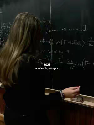 A woman in a black outfit stands with her back to the camera, writing equations on a chalkboard. Text overlays indicate academic themes.