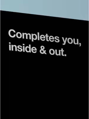 The image is a close up shot of a black rectangle on a light blue background. In the center of the rectangle, the text 'Completes you, inside & out.' is written in white, sans-serif font.
