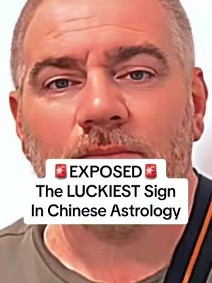 A close-up shot of a man with a short beard and graying hair, the background is blurred. A white rectangular banner is placed over the man's mouth and lower face, it is centered and displays the text in two rows, written in a bold font: