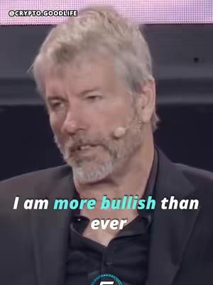A medium shot of a gray-haired man in a suit, speaking with a microphone. The image is overlaid with the text "I am more bullish than ever".