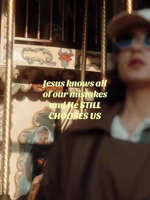 The cover image is a vertical shot featuring a person in the foreground and a carousel in the background. The person, seen from the shoulders up, is wearing sunglasses and a hat, with their face slightly out of focus. The background shows a carousel with ornate detailing and vertical poles, bathed in warm, golden light. Text is overlaid on the image, centered, and stacked vertically, using a yellow font that contrasts with the darker background.