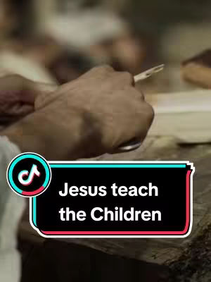 The cover image shows a close-up of a hand holding a small, pointed object, possibly a pen or a stylus, against a blurry background. A text overlay in a rounded rectangle reading "Jesus teach the Children" is visible at the bottom of the frame.