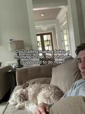 The video cover shows a young man reclining on a sofa with a fluffy dog. The man is looking at the camera with a slightly inquisitive expression. A text overlay reads: Day trading making $6k in a morning is cool. But what am I supposed to do now?