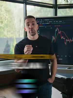 A man stands in front of a computer screen displaying a stock chart, with a window behind him. The image has a professional, informational tone.