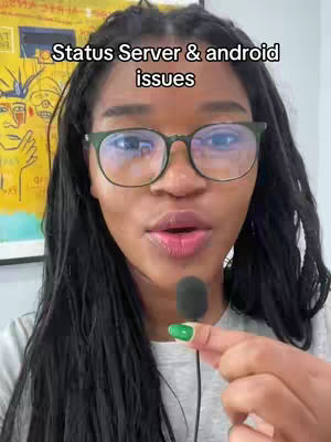 A medium shot of a woman with long, dark hair and glasses, looking directly at the camera and speaking. The background has a colorful, abstract painting. The woman is holding a microphone.